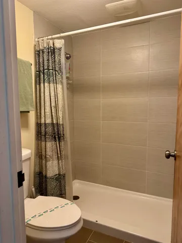a bathroom with a toilet and shower