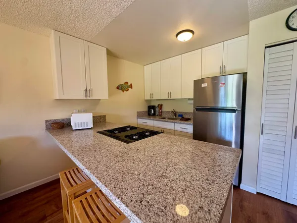 a kitchen with a stove and a refrigerator