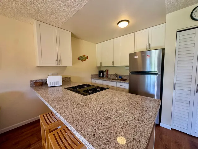 a kitchen with a stove and a refrigerator