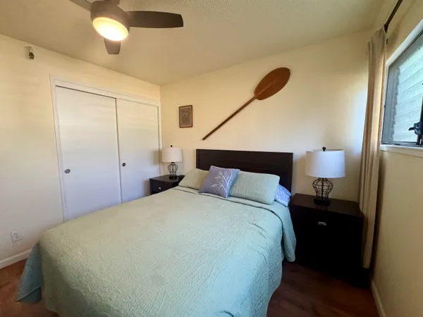 a bedroom with a bed and a lamp