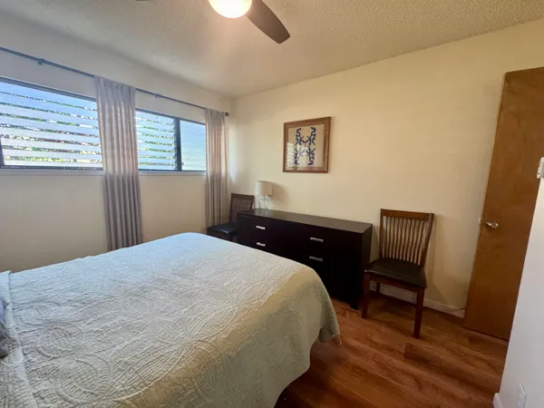 a bedroom with a bed and a chair