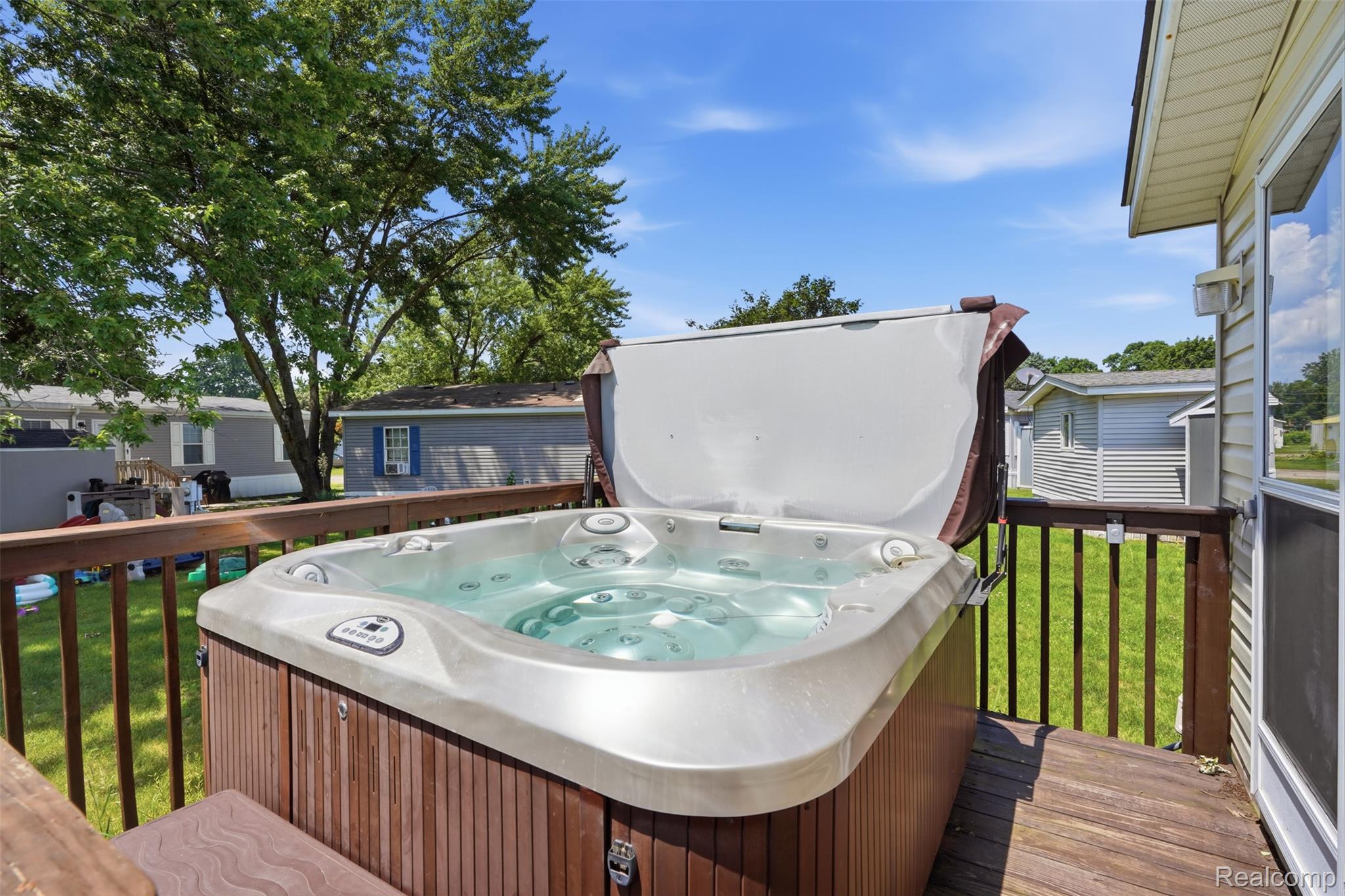 4634 Butternut Street Clarkston, MI 48348 - Photo 22 of 28 Outdoor spa situated on a wood-finish deck with a protective railing