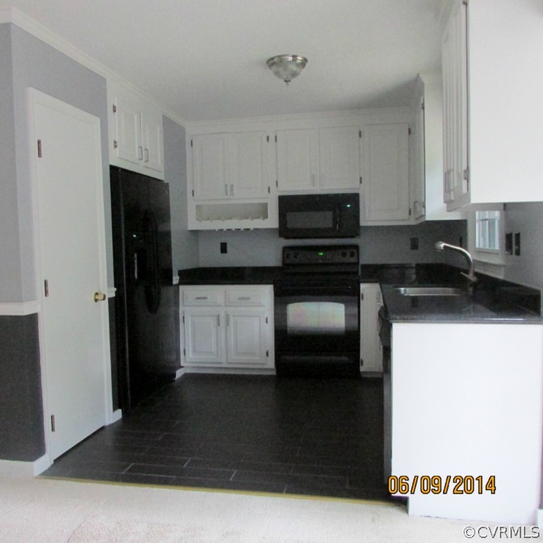 2900 Shiloh Church Road Midlothian, VA 23112 - Photo 6 of 15 a kitchen with a sink a refrigerator and cabinets