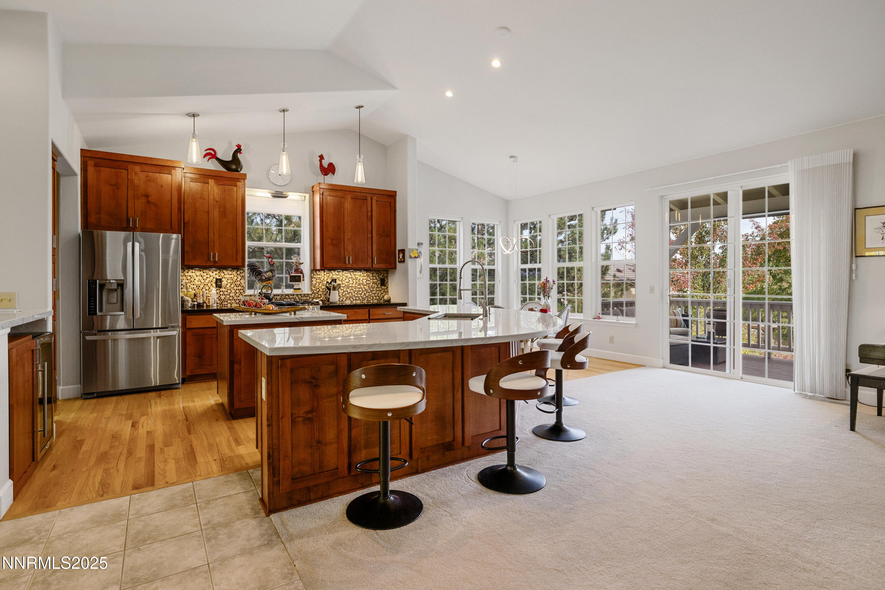 14240 Bandolier Court Reno, NV 89511 - Photo 11 of 47 a kitchen with stainless steel appliances kitchen island granite countertop a sink and cabinets