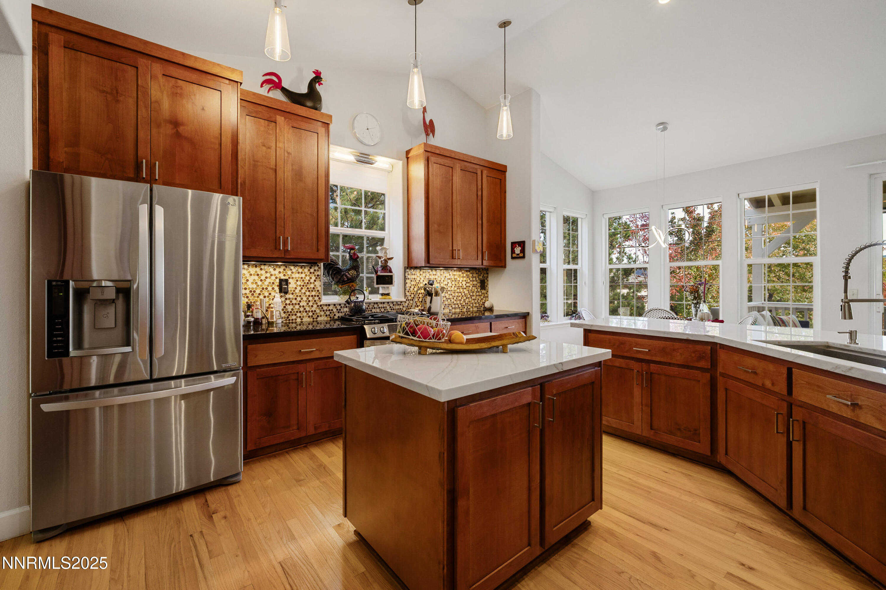 14240 Bandolier Court Reno, NV 89511 - Photo 13 of 47 a kitchen with kitchen island granite countertop a sink appliances a counter space and a window