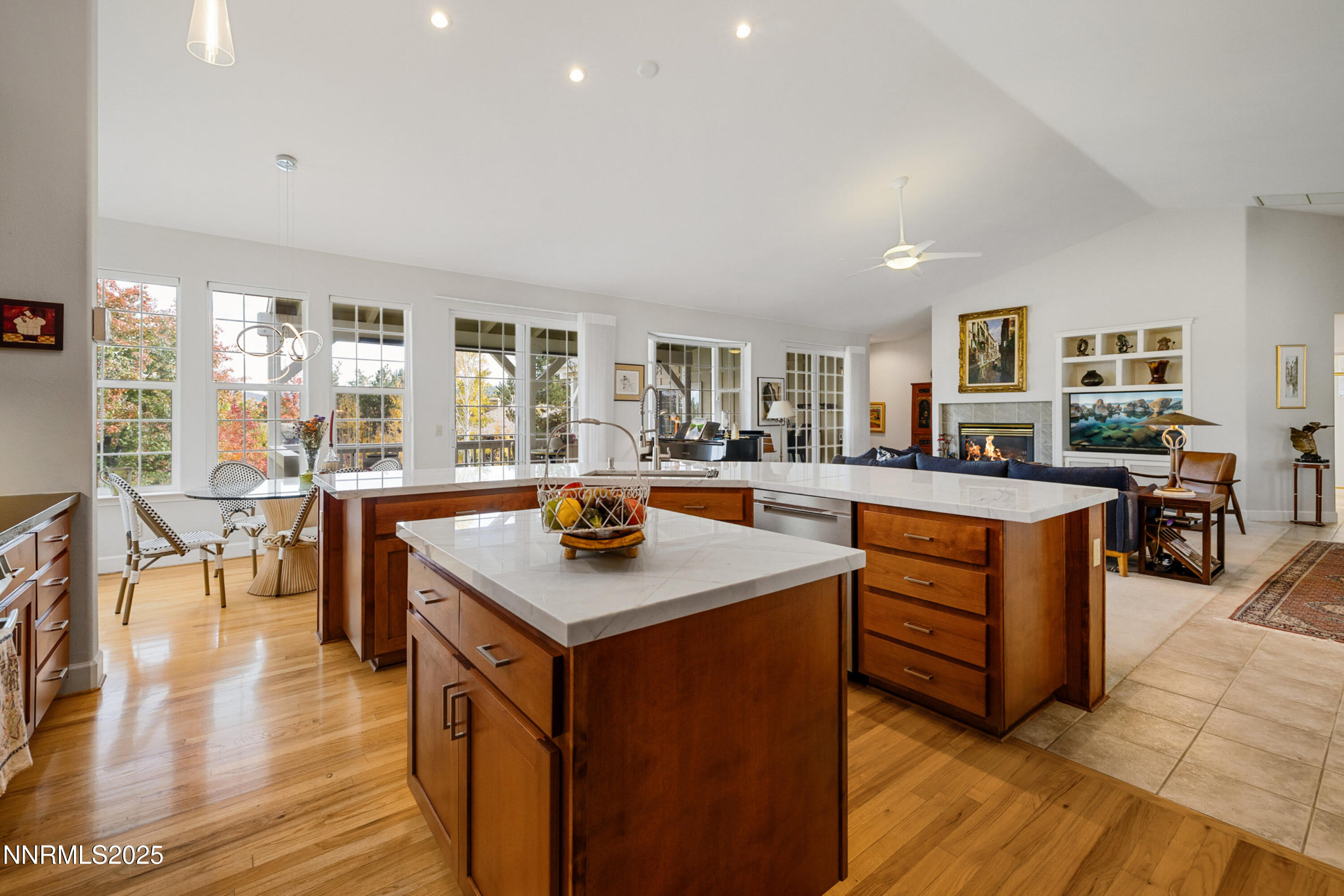 14240 Bandolier Court Reno, NV 89511 - Photo 13 of 47 a kitchen with stainless steel appliances granite countertop a table and chairs in it