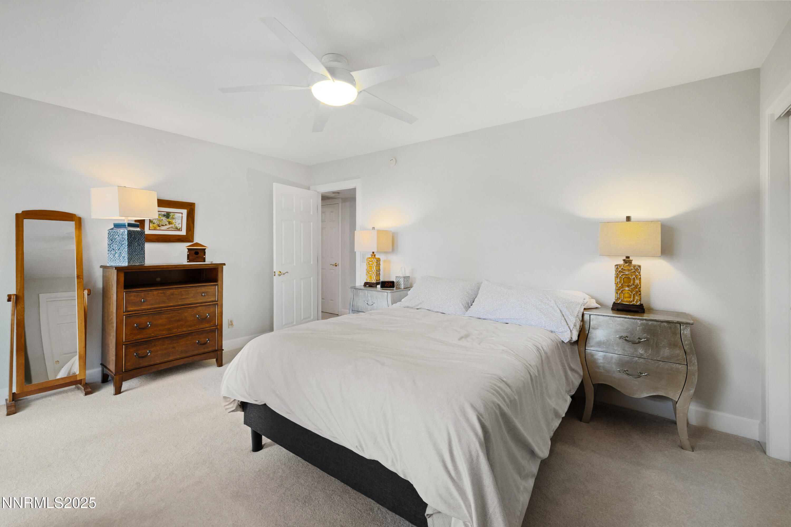 14240 Bandolier Court Reno, NV 89511 - Photo 30 of 47 a bedroom with a bed and a chandelier