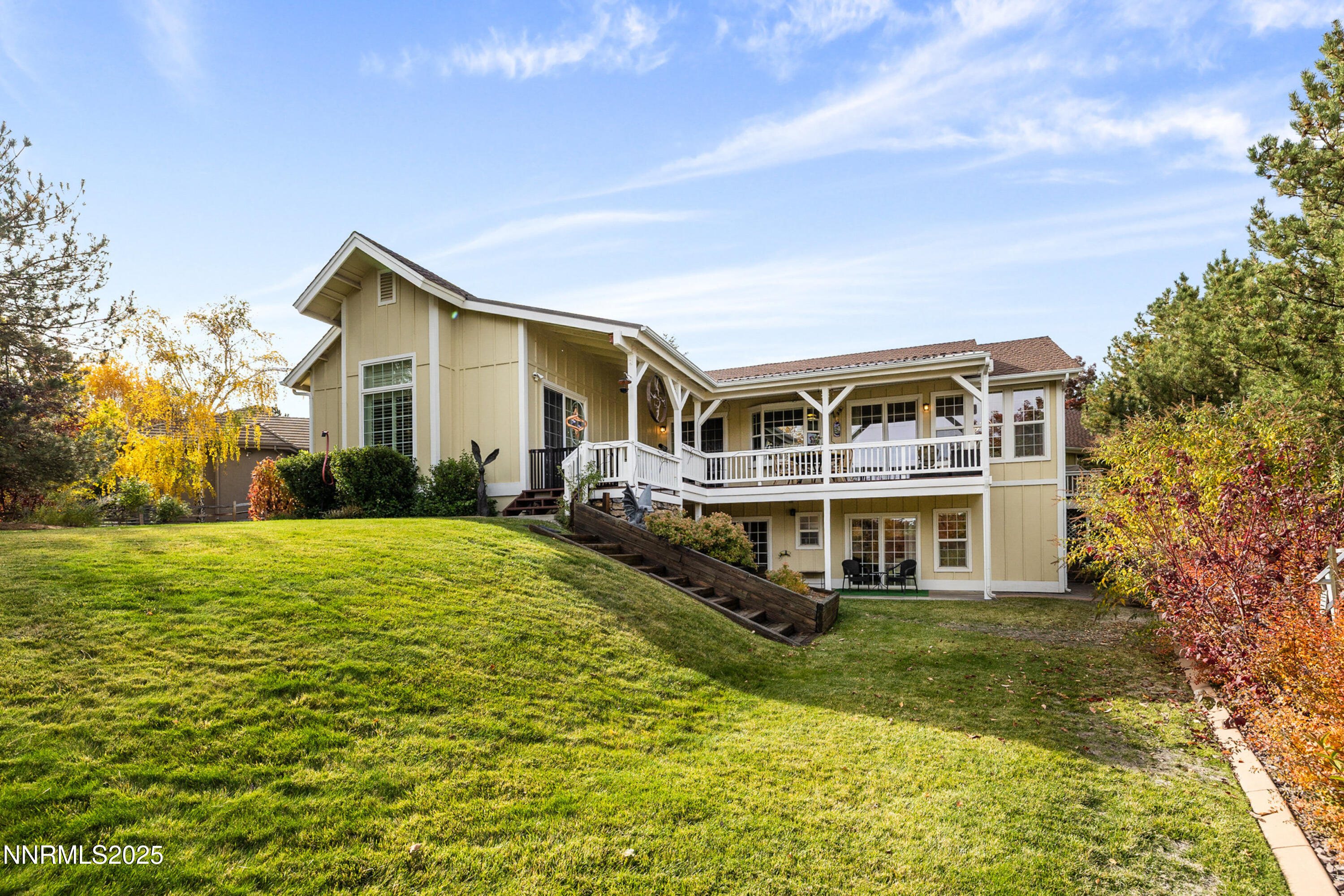 14240 Bandolier Court Reno, NV 89511 - Photo 37 of 47 a view of a house with a big yard and large trees