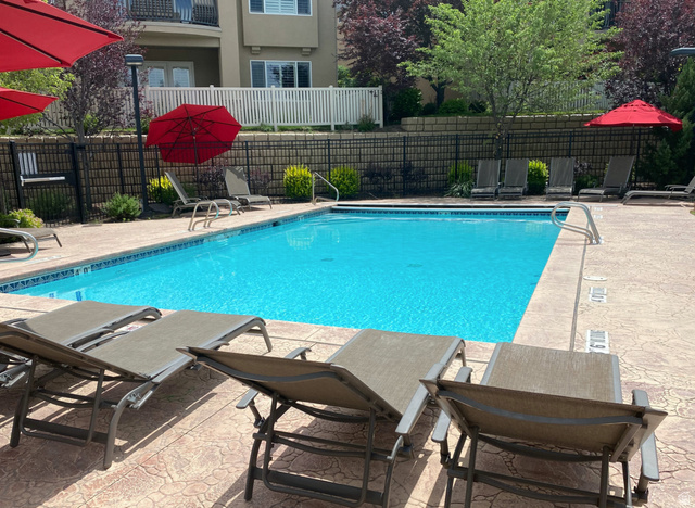 1562 Fairway Ridge Road Draper, UT 84020 - Photo 60 of 60 Refreshing swimming pool featuring a patterned concrete deck, perimeter fencing, and mature landscaping
