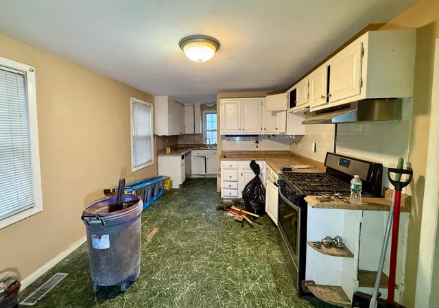 a kitchen with a sink and cabinets