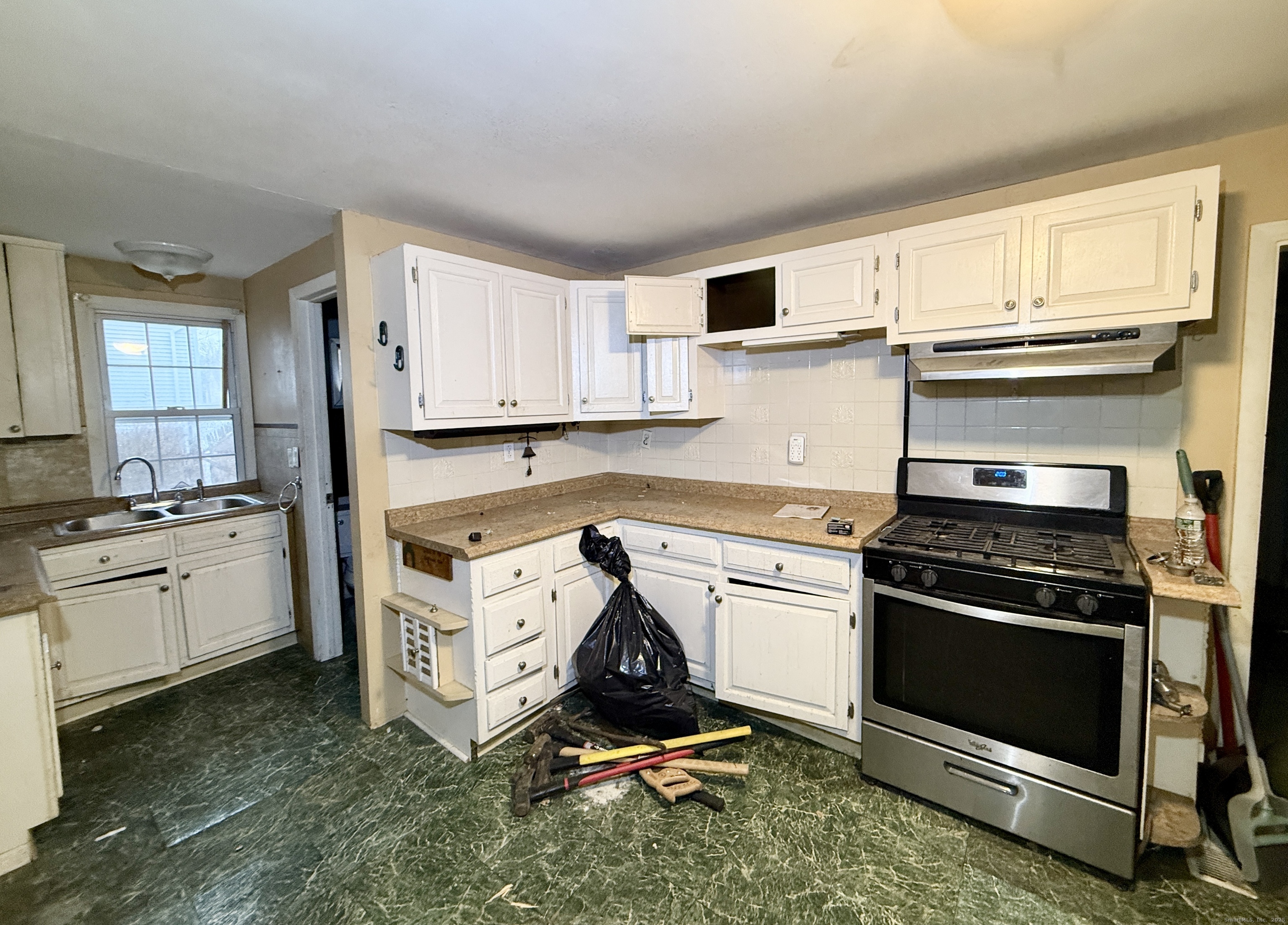 201 Prospect Street Ansonia, CT 06401 - Photo 13 of 28 a kitchen with appliances cabinets and a window
