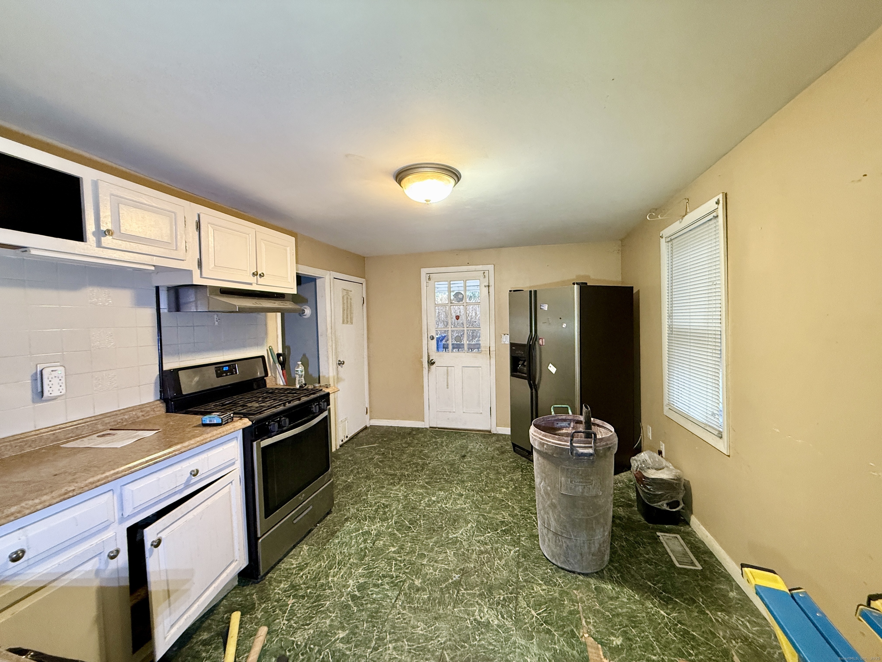 201 Prospect Street Ansonia, CT 06401 - Photo 14 of 28 a kitchen with refrigerator a stove and a sink