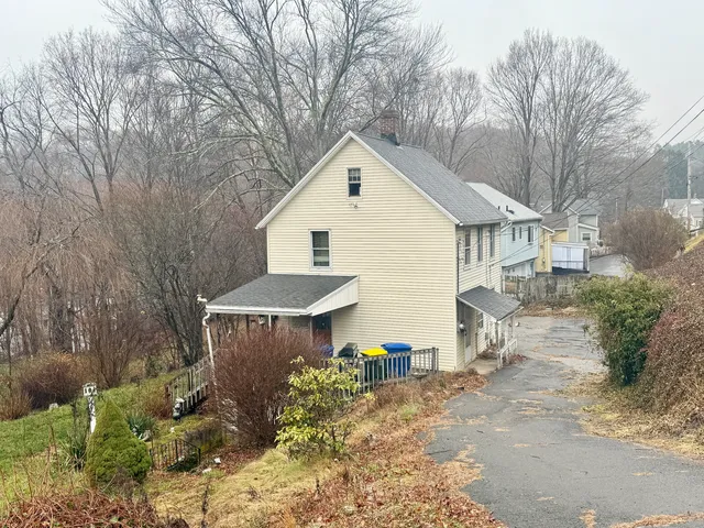 a view of a house with a yard and covered with snow