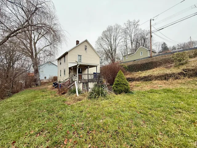 a view of a house with a yard covered in snow