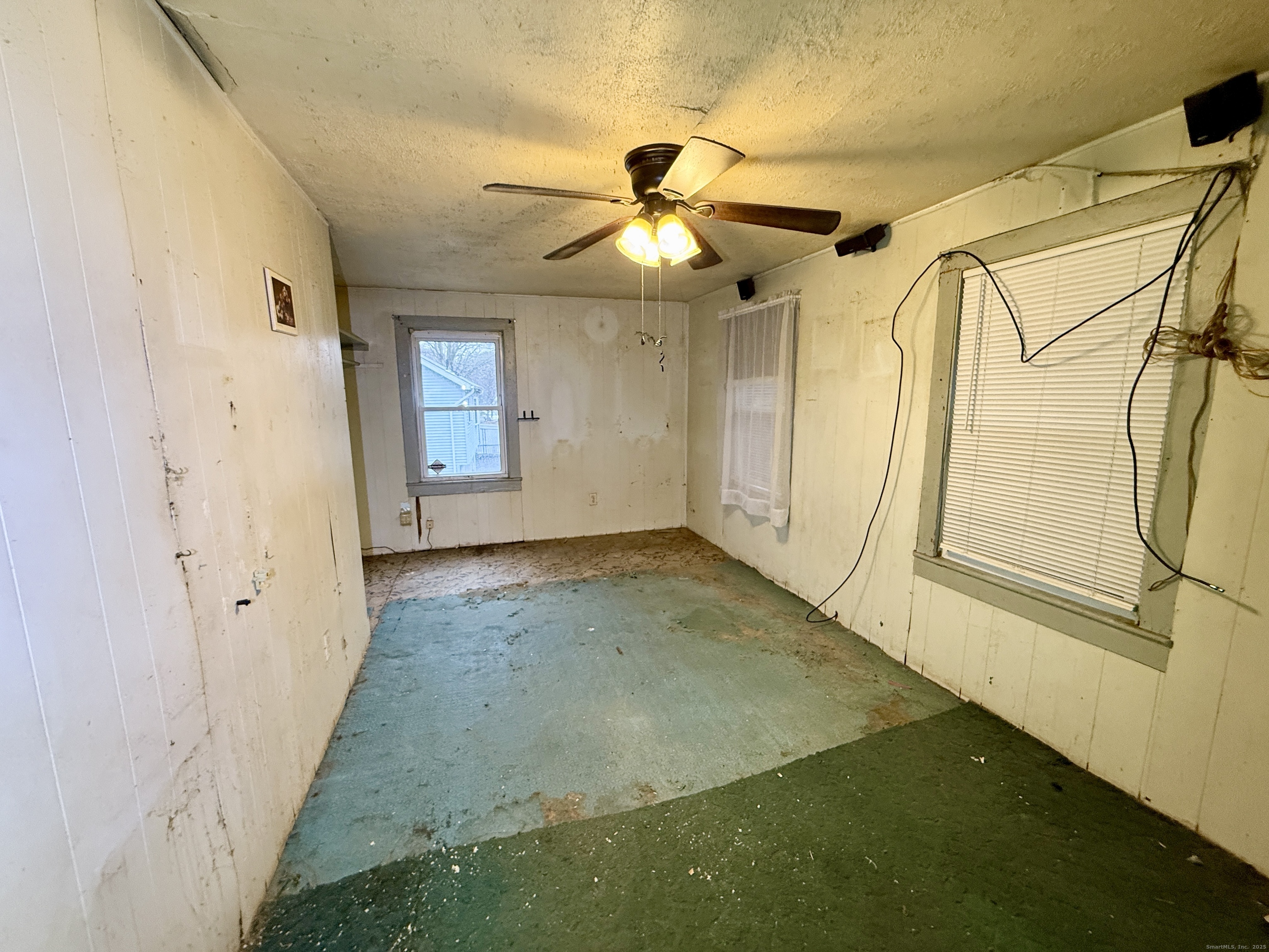 201 Prospect Street Ansonia, CT 06401 - Photo 10 of 28 a view of a big room with wooden floor and windows