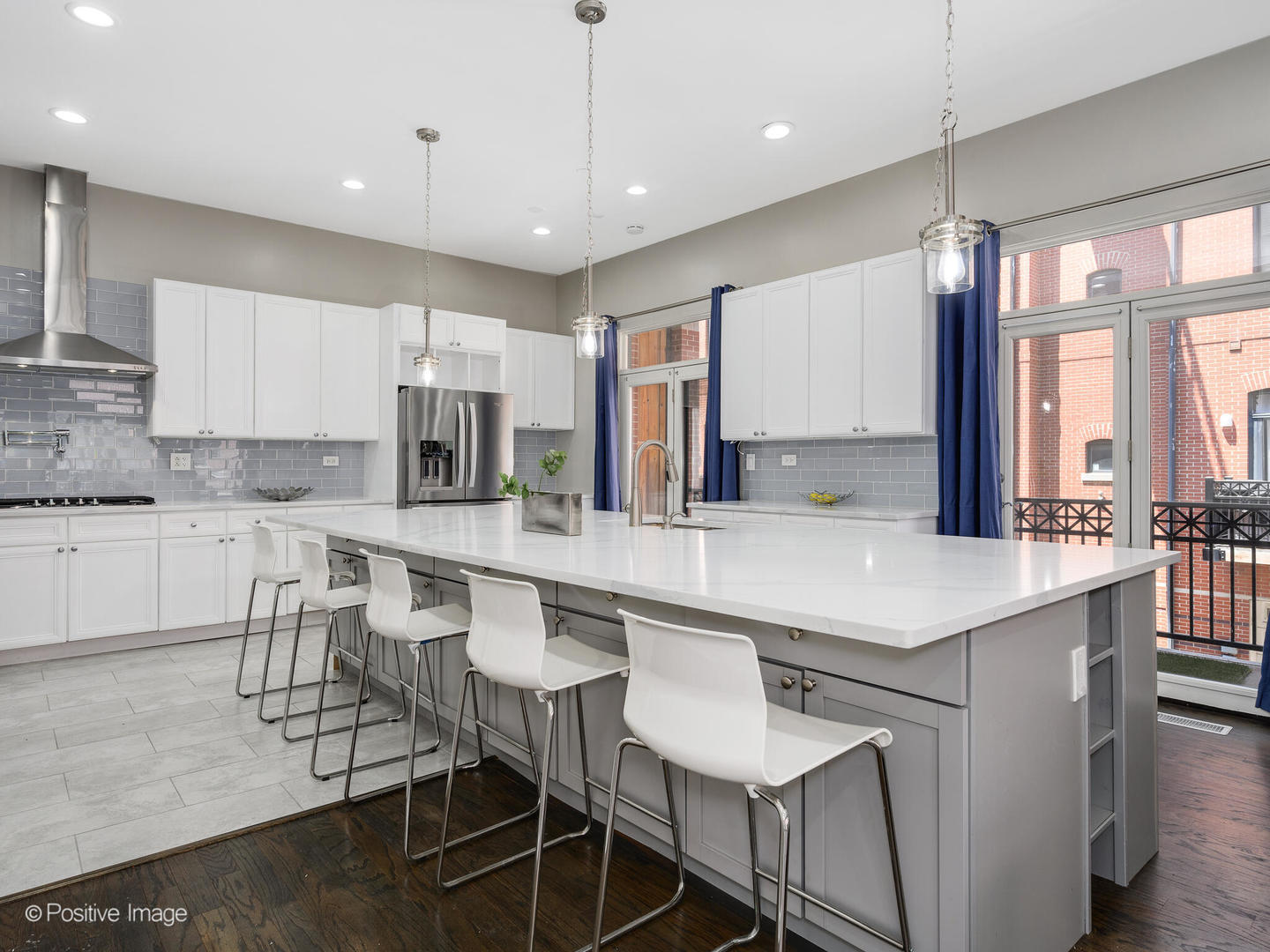 910 West Village Court Chicago, IL 60608 - Photo 15 of 44 a kitchen with kitchen island granite countertop a table chairs sink and cabinets