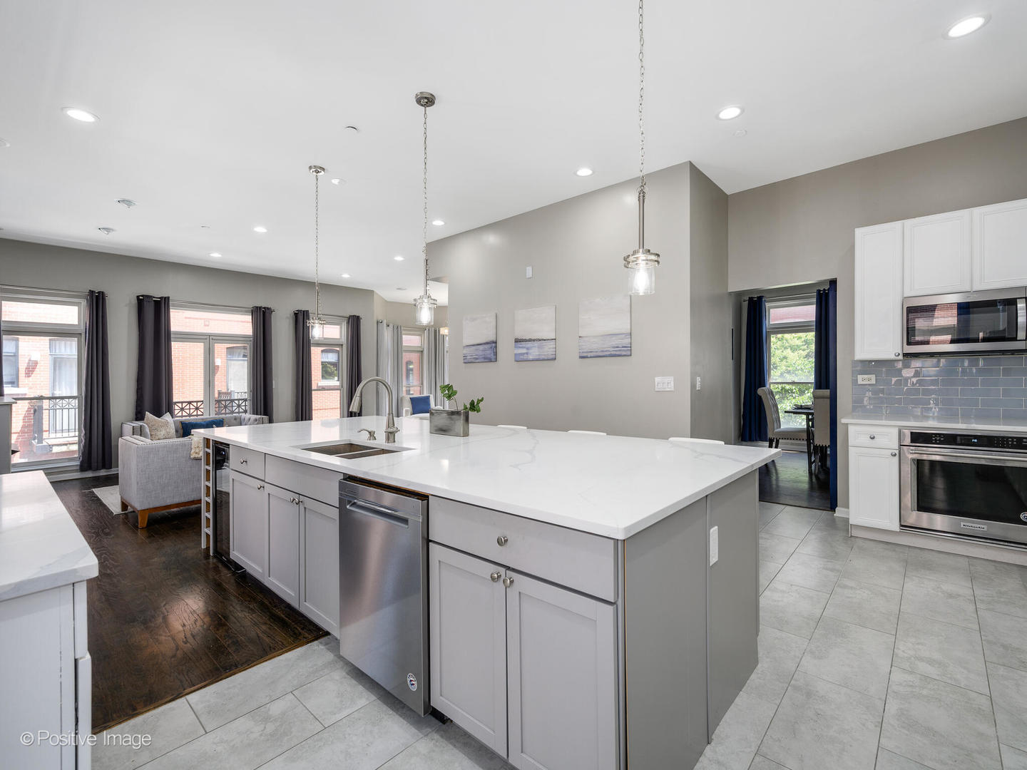 910 West Village Court Chicago, IL 60608 - Photo 17 of 44 a large white kitchen with a sink a stove and a refrigerator