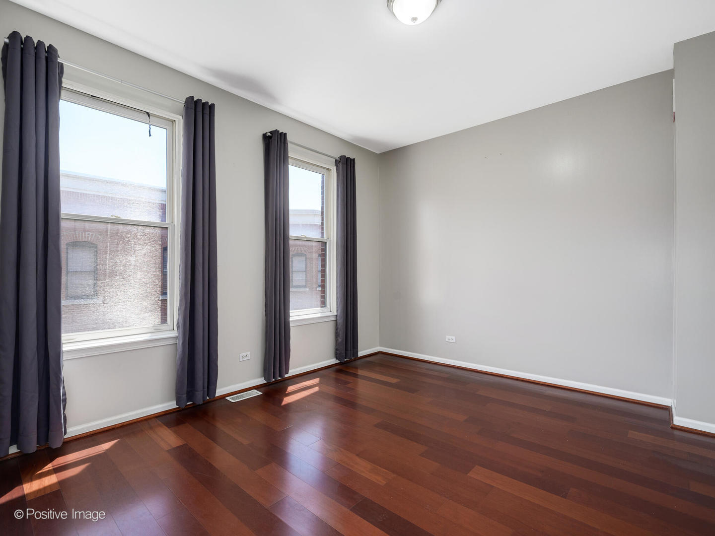 910 West Village Court Chicago, IL 60608 - Photo 24 of 44 an empty room with wooden floor and windows