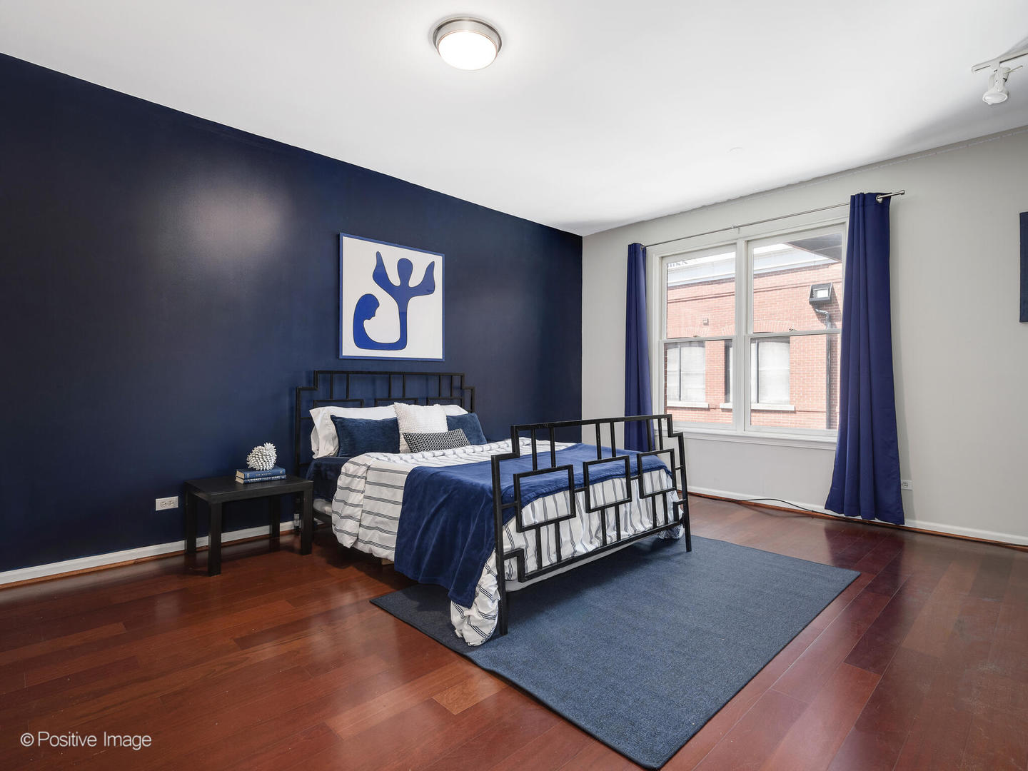 910 West Village Court Chicago, IL 60608 - Photo 25 of 44 a bed sitting in a spacious bedroom next to a window