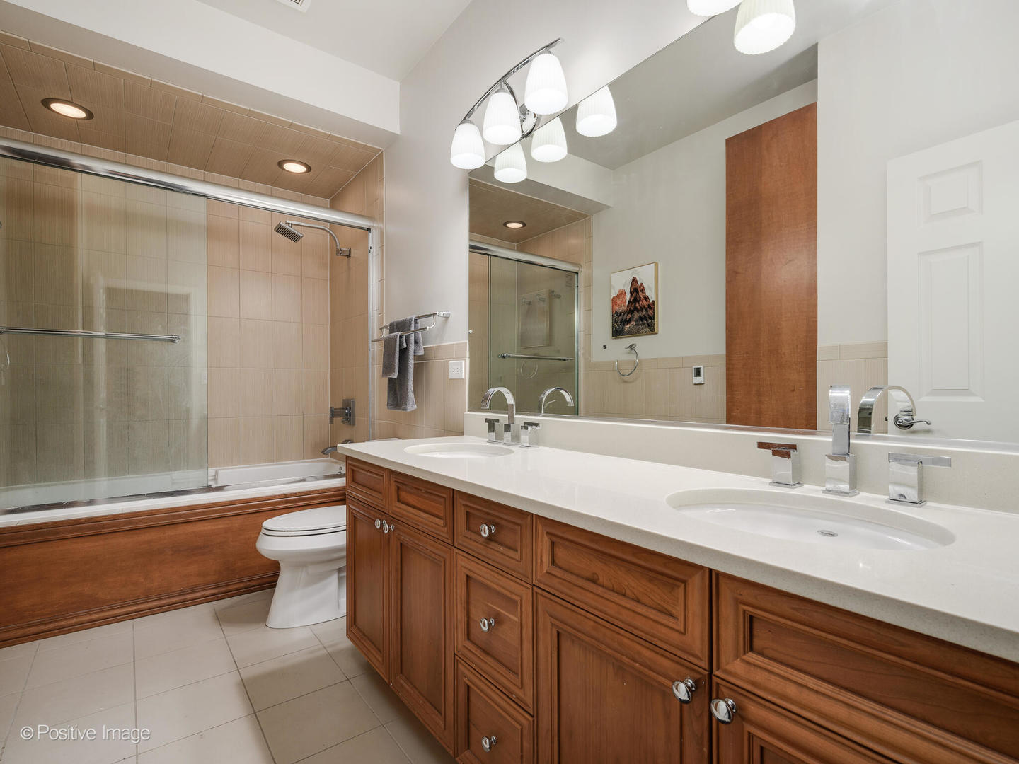 910 West Village Court Chicago, IL 60608 - Photo 26 of 44 a bathroom with a double vanity sink toilet mirror and bathtub