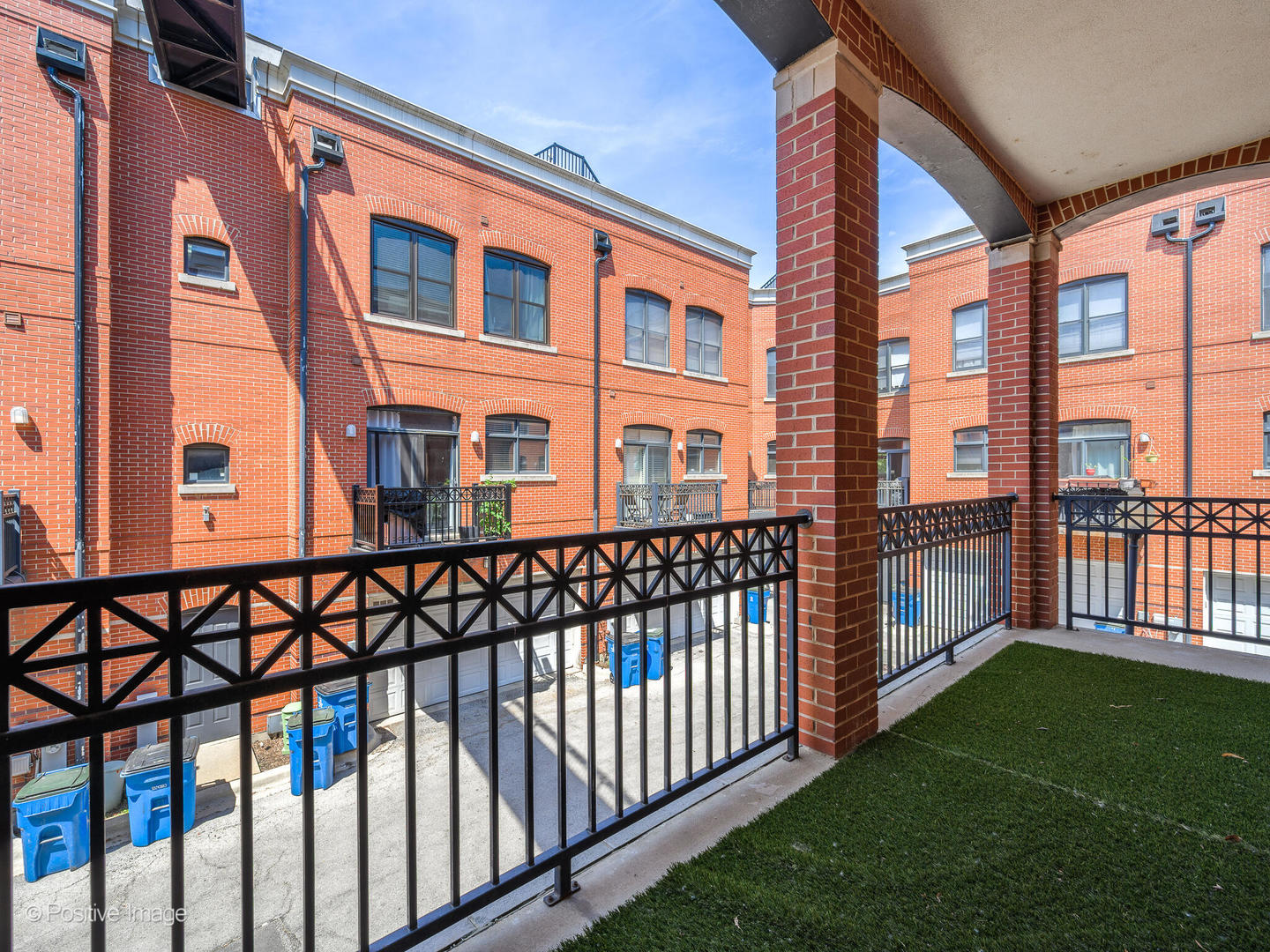 910 West Village Court Chicago, IL 60608 - Photo 27 of 44 a view of a large building next to a yard