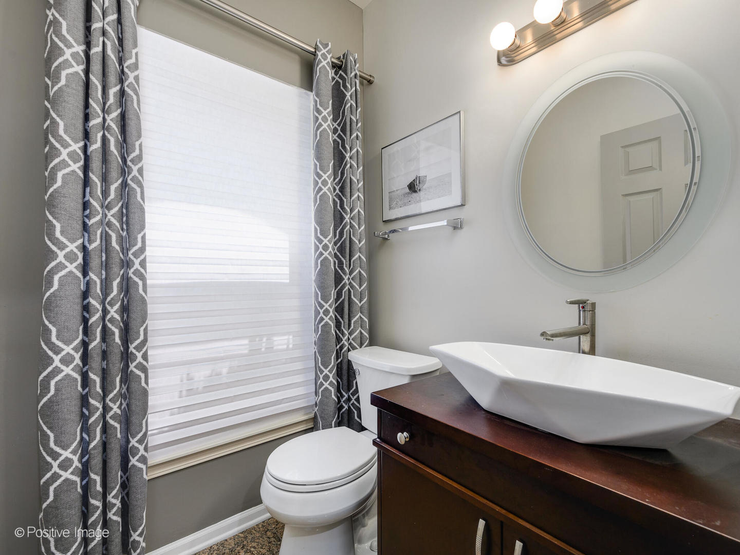 910 West Village Court Chicago, IL 60608 - Photo 7 of 44 a bathroom with a sink a toilet and a mirror