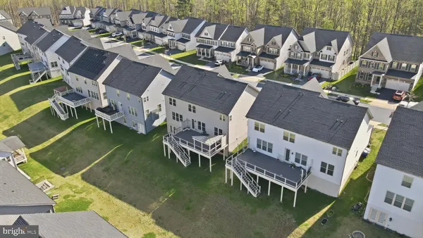 an aerial view of a house with outdoor space and lake view