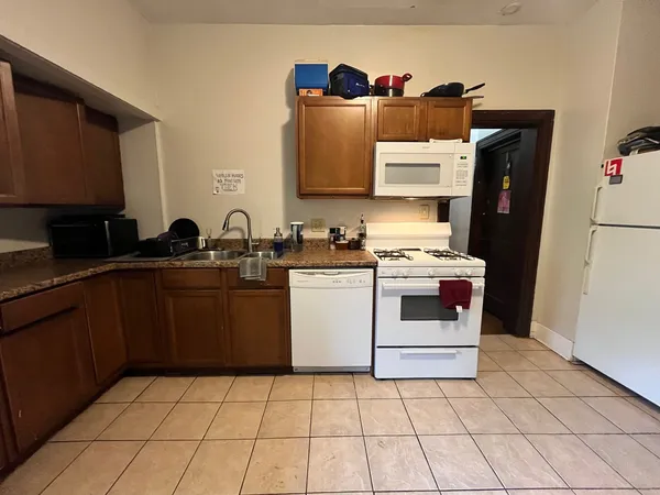 a utility room with cabinets washer and dryer