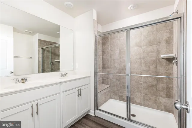 a bathroom with a shower sink and mirror