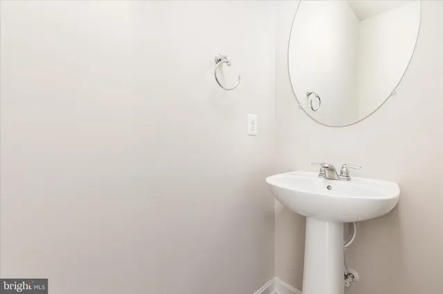 a bathroom with a sink a mirror and a shower