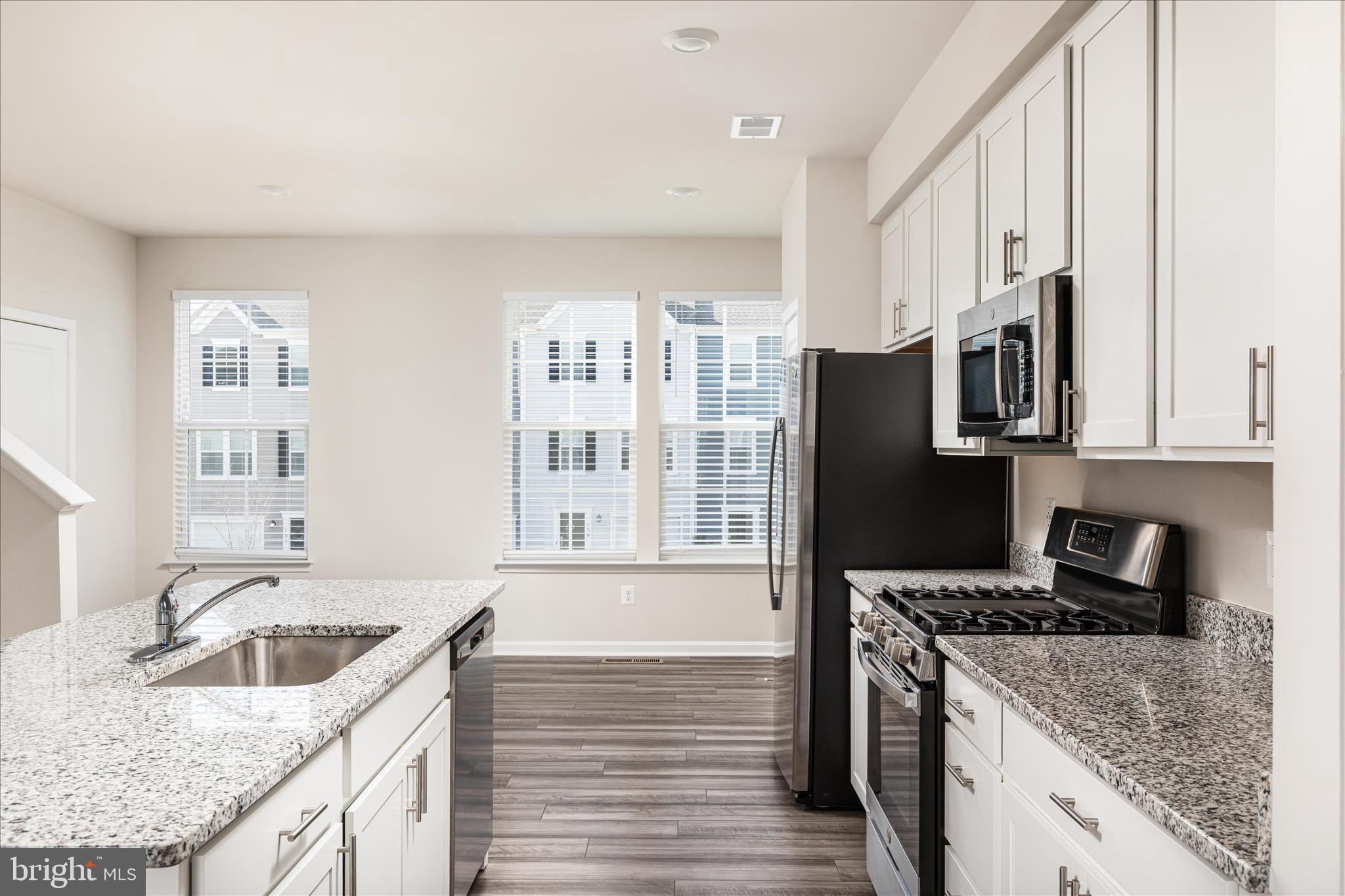 140 Tye Court Winchester, VA 22602 - Photo 19 of 31 a kitchen with stainless steel appliances granite countertop a sink stove and refrigerator