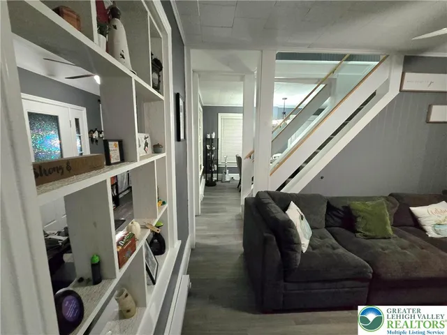 a living room with furniture and stairs