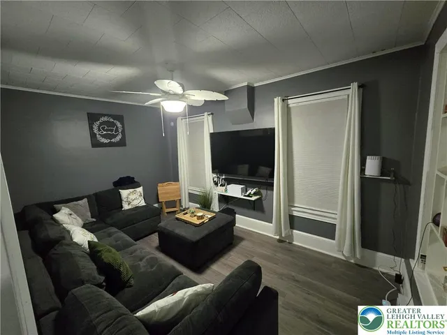 a living room with furniture and a flat screen tv