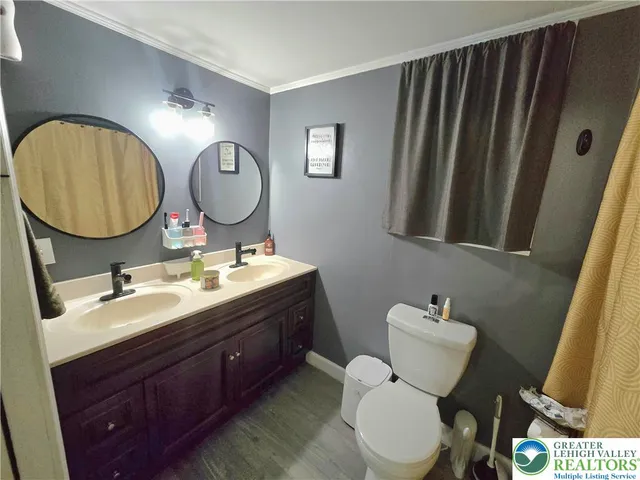 a bathroom with a toilet a sink and a mirror