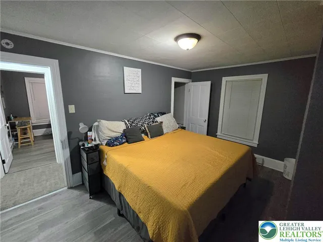 a bed sitting in a bedroom next to a window