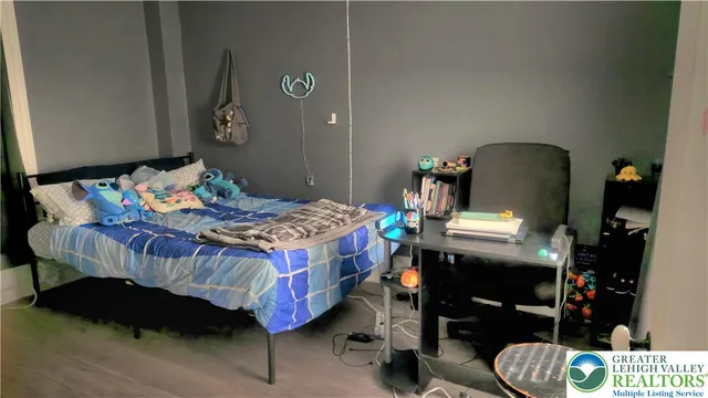 a bedroom with a bed and dresser