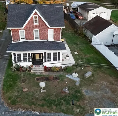 a aerial view of a house with yard