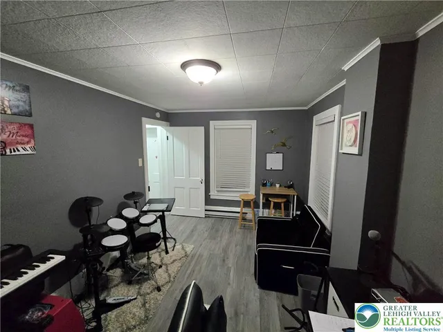 a hallway with wooden floor and furniture