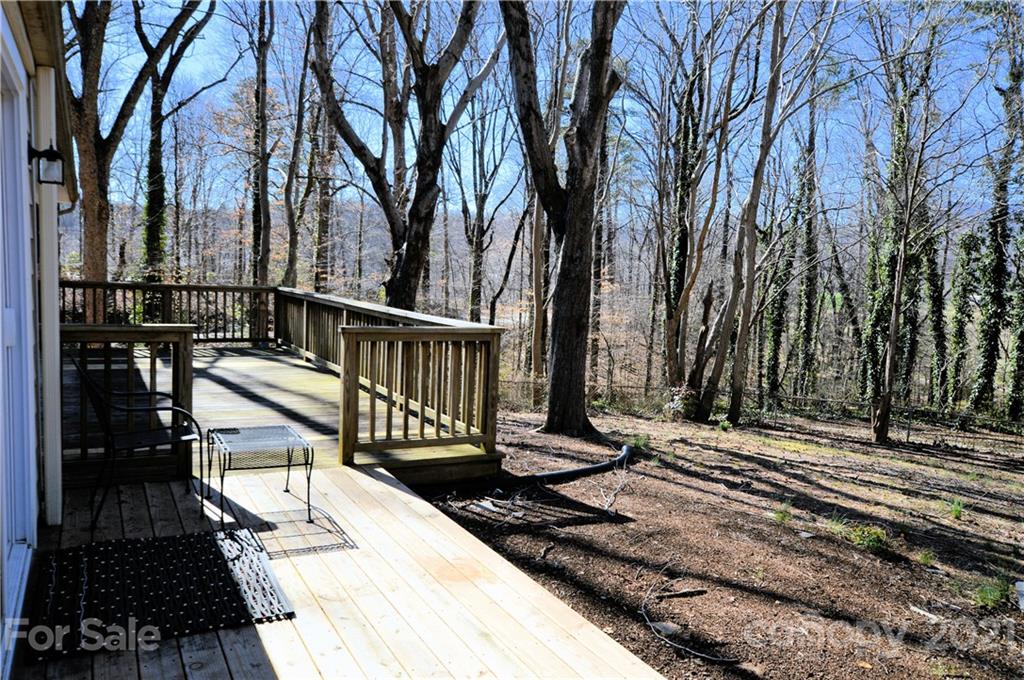 200 Bradshaw Road Tryon, NC 28782 - Photo 19 of 24 a view of a balcony with wooden floor and trees