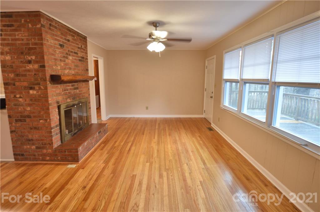 200 Bradshaw Road Tryon, NC 28782 - Photo 6 of 24 wooden floor in an empty room with a fireplace