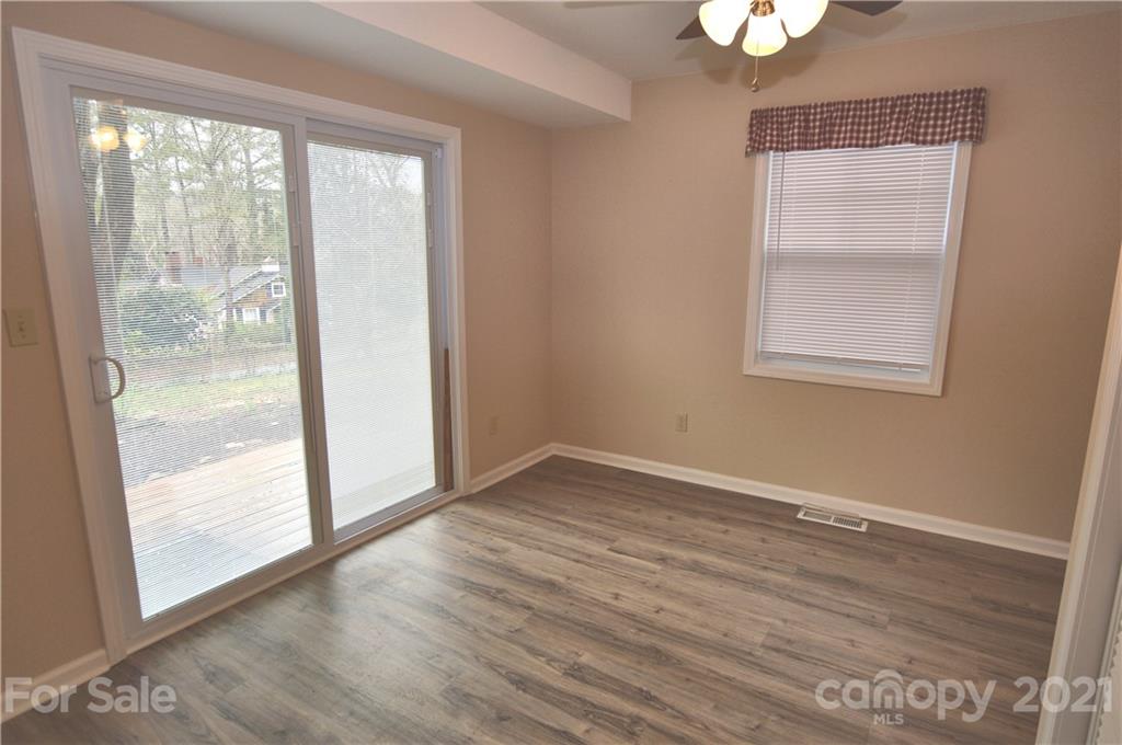 200 Bradshaw Road Tryon, NC 28782 - Photo 8 of 24 an empty room with wooden floor and windows