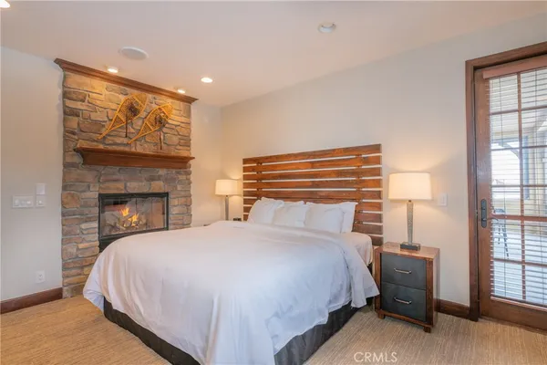 a bedroom with a bed and a fireplace