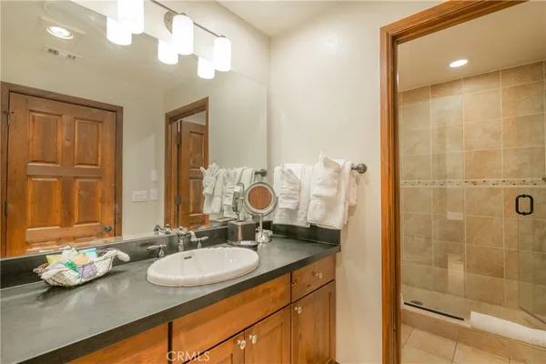 a bathroom with a sink double vanity and a mirror