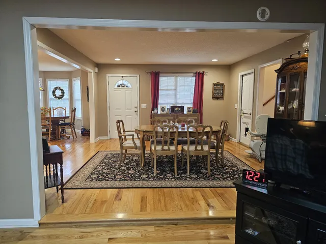 a bed sitting in a bedroom next to a lamp with wooden floor