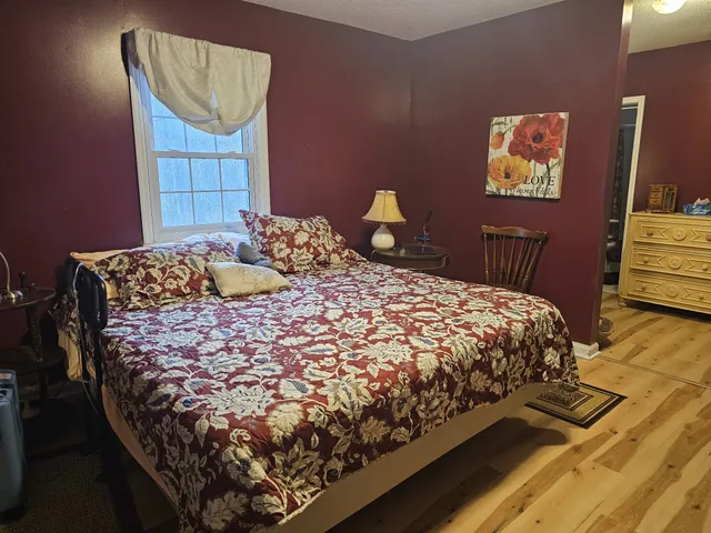 a bedroom with a bed and a dresser