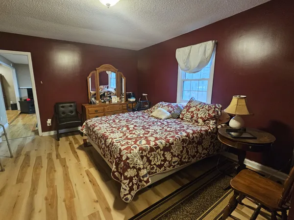 a bedroom with a bed and a mirror