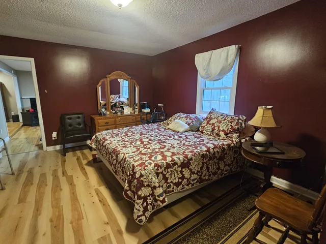 a bedroom with a bed and a mirror