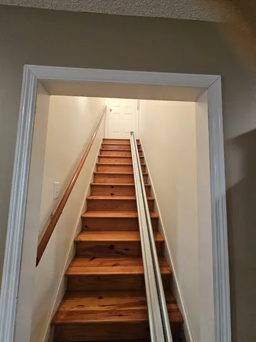 a large bed sitting in a bedroom next to a window