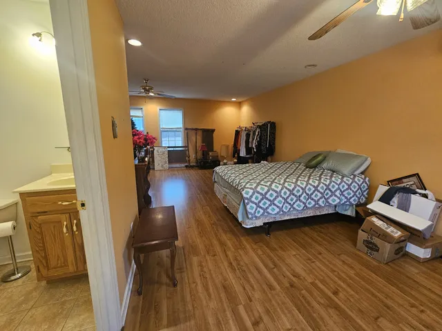 a view of a livingroom with hardwood floor and a ceiling fan