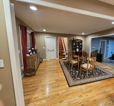 a kitchen with kitchen island granite countertop wooden floors a stove and a sink